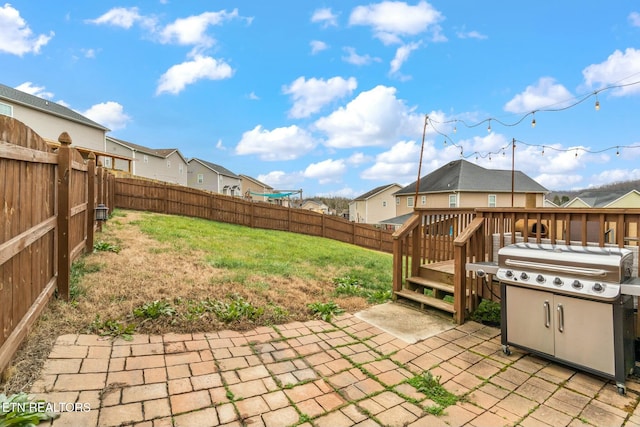 view of patio with area for grilling and a deck