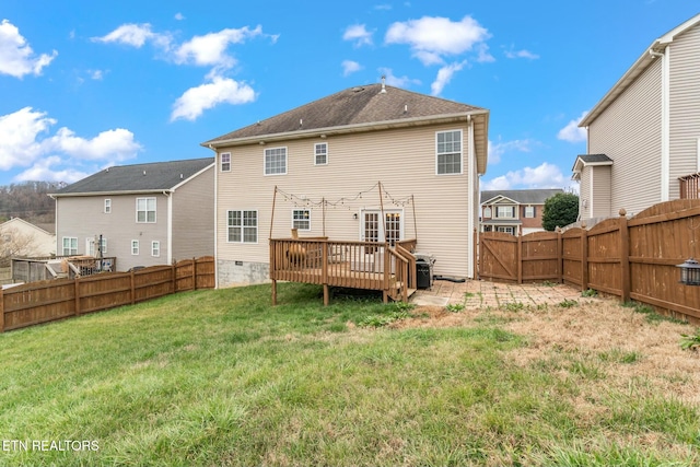 back of house with a lawn and a deck