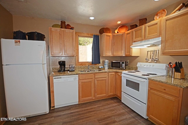 kitchen featuring light stone countertops, sink, light brown cabinets, dark hardwood / wood-style flooring, and white appliances