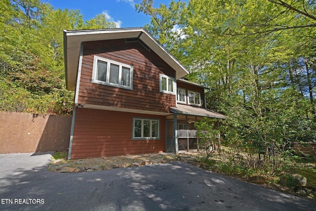 view of side of home with covered porch