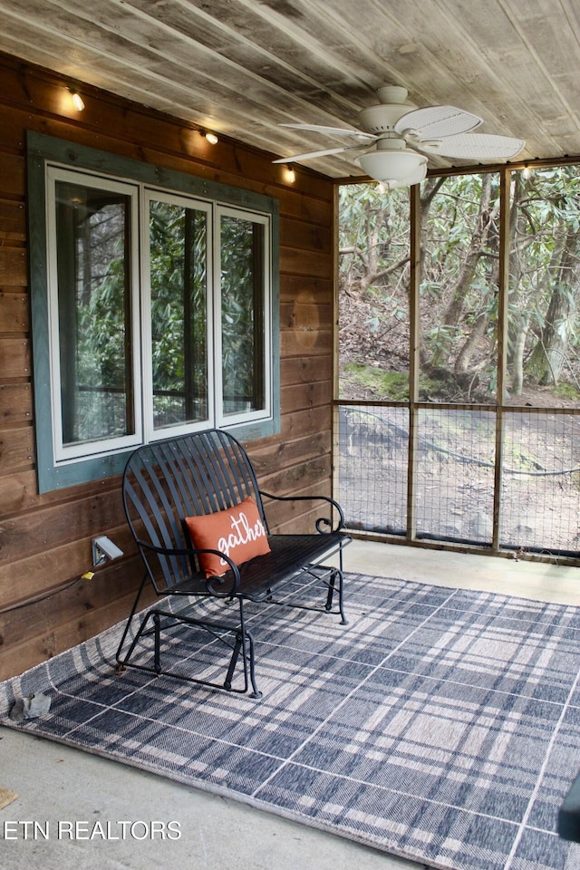 sunroom with plenty of natural light and wooden ceiling
