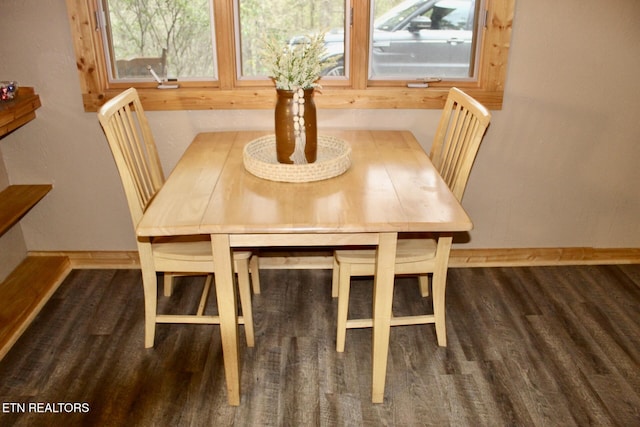 unfurnished dining area with baseboards, a healthy amount of sunlight, and wood finished floors