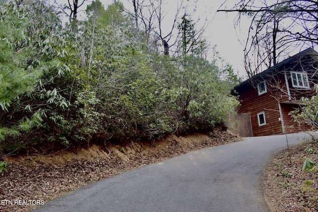 view of side of home with aphalt driveway