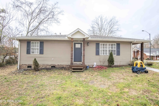 single story home featuring a front yard