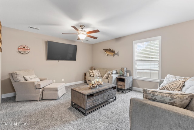 carpeted living area featuring baseboards, visible vents, and a ceiling fan