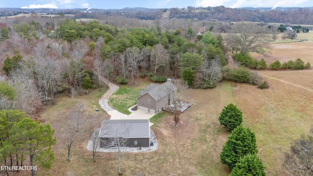 birds eye view of property featuring a view of trees