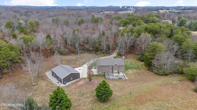 drone / aerial view featuring a wooded view