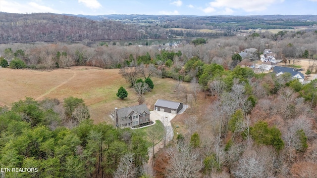 birds eye view of property with a rural view and a wooded view