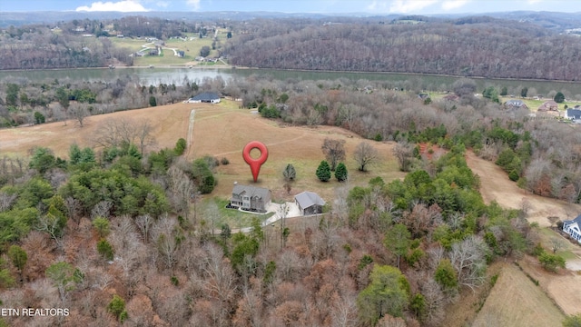 aerial view featuring a water view and a forest view