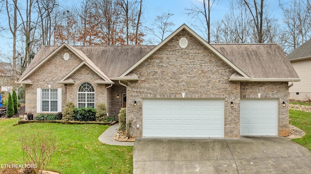 view of front of house with a front lawn and a garage