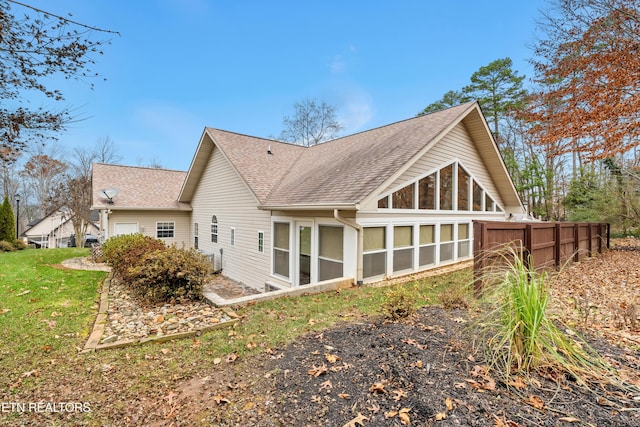 back of house featuring a sunroom