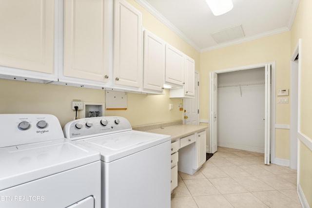 washroom with washer and dryer, light tile patterned floors, cabinets, and crown molding