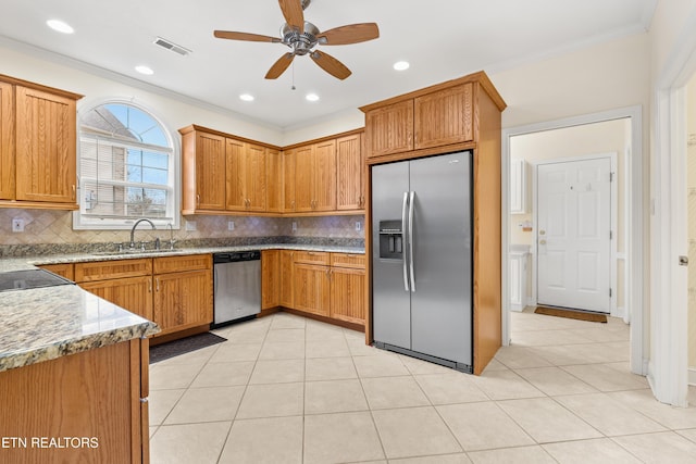 kitchen with tasteful backsplash, ornamental molding, stainless steel appliances, ceiling fan, and sink