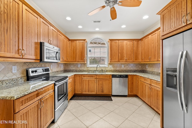 kitchen with ceiling fan, sink, stainless steel appliances, light stone counters, and light tile patterned floors