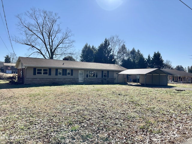 ranch-style home with a front yard and a carport