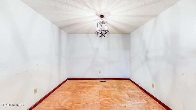 unfurnished dining area featuring a textured ceiling