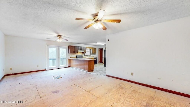 interior space with french doors, a textured ceiling, and ceiling fan