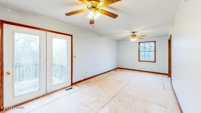 unfurnished room featuring ceiling fan and french doors