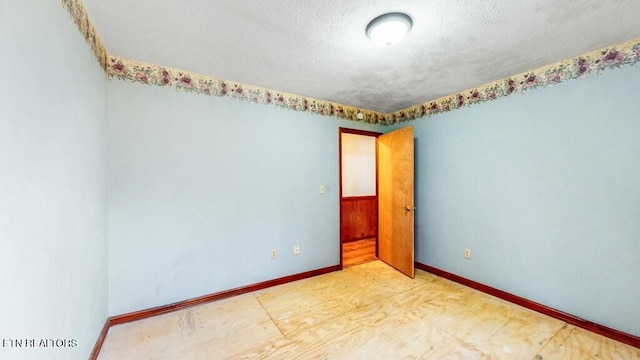 empty room featuring a textured ceiling