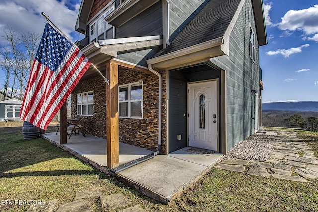 entrance to property with a lawn