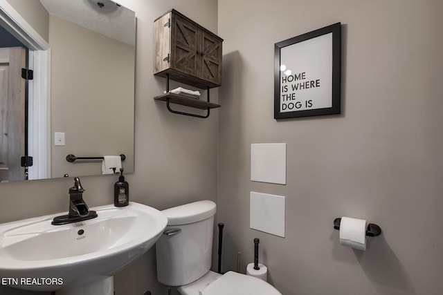 bathroom featuring sink and toilet