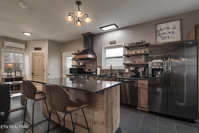 kitchen featuring custom exhaust hood, sink, decorative backsplash, a wall mounted AC, and stainless steel appliances