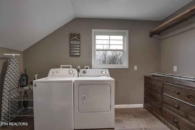 laundry area featuring washing machine and dryer and light tile patterned floors