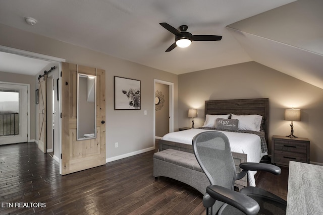 bedroom with lofted ceiling, a barn door, ceiling fan, and dark wood-type flooring