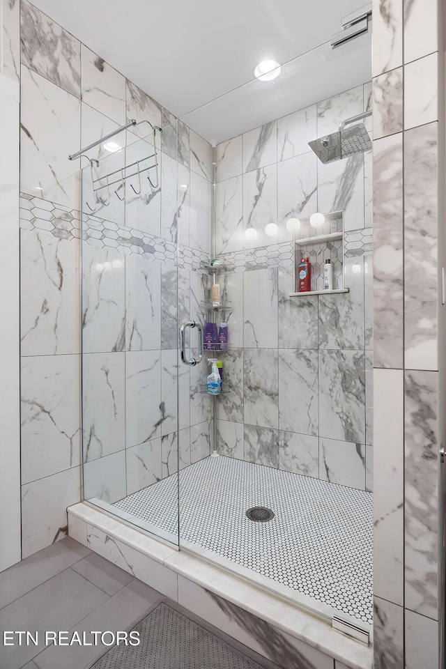 bathroom with tile patterned flooring and an enclosed shower