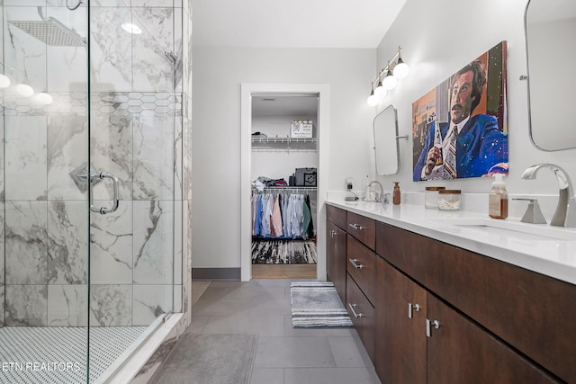 bathroom featuring tile patterned floors, vanity, and an enclosed shower