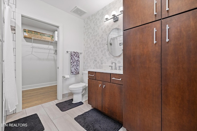 bathroom with hardwood / wood-style floors, vanity, and toilet