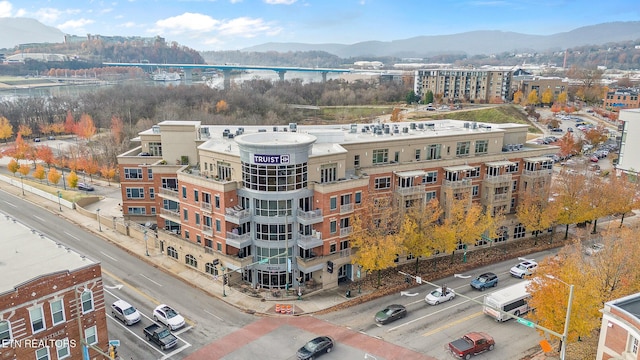 drone / aerial view featuring a water and mountain view