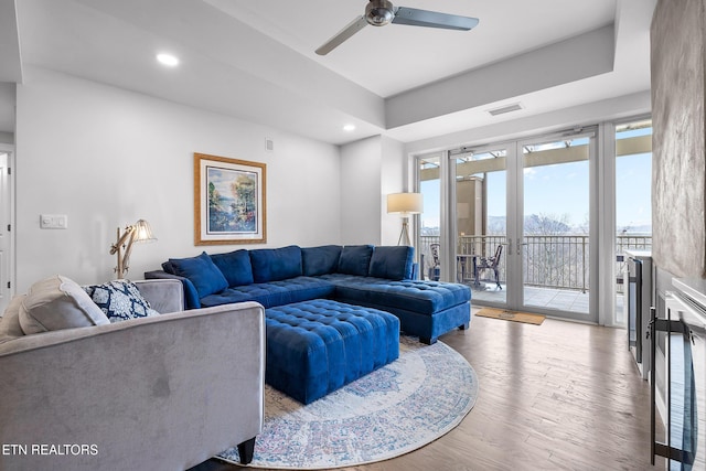 living room featuring french doors, light hardwood / wood-style floors, and ceiling fan