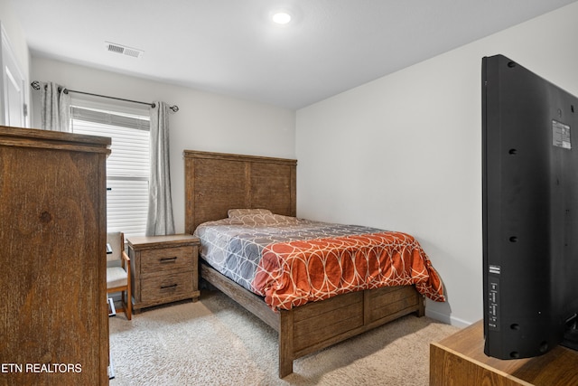 bedroom featuring light carpet