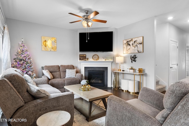 living room with ceiling fan and dark wood-type flooring