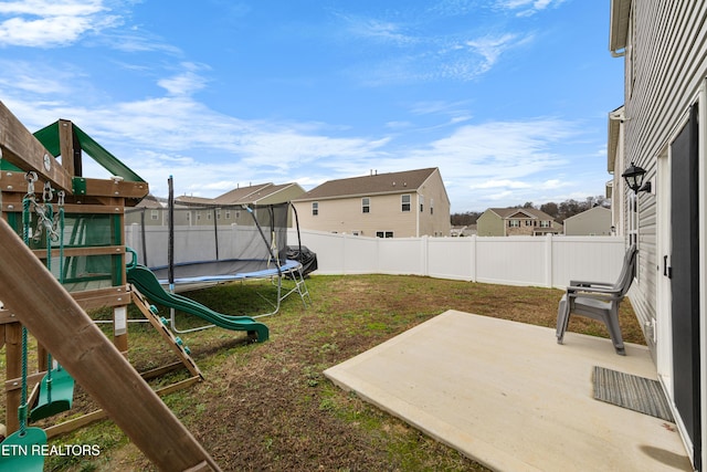 view of yard with a playground, a patio, and a trampoline