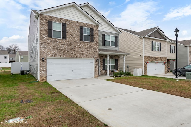 view of front of home with central air condition unit, a front lawn, and a garage