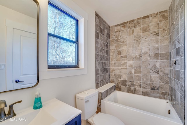 full bathroom featuring vanity, toilet, and tiled shower / bath combo