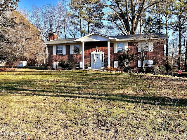 raised ranch featuring a front lawn