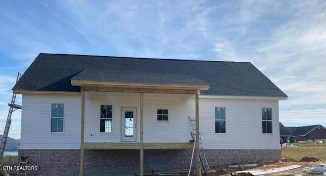 back of house featuring a porch