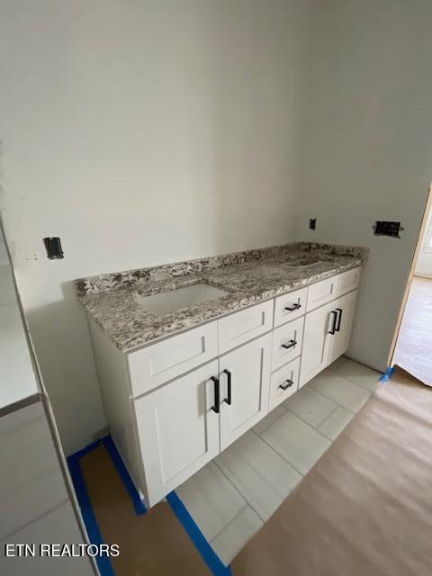 bathroom featuring tile patterned flooring and vanity