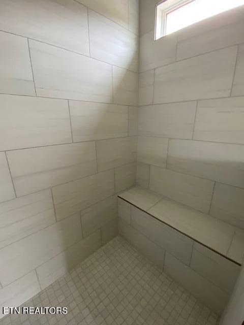 bathroom with a tile shower