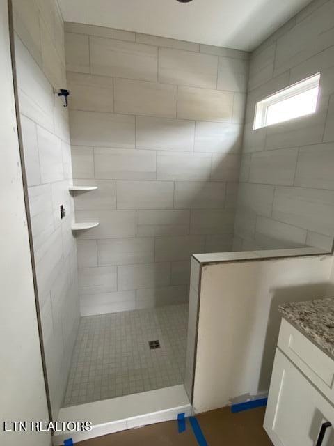 bathroom with tiled shower