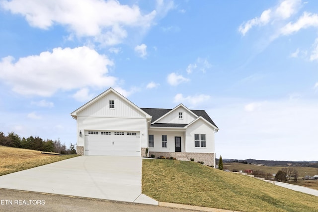 modern farmhouse style home with a front yard, brick siding, concrete driveway, a garage, and board and batten siding