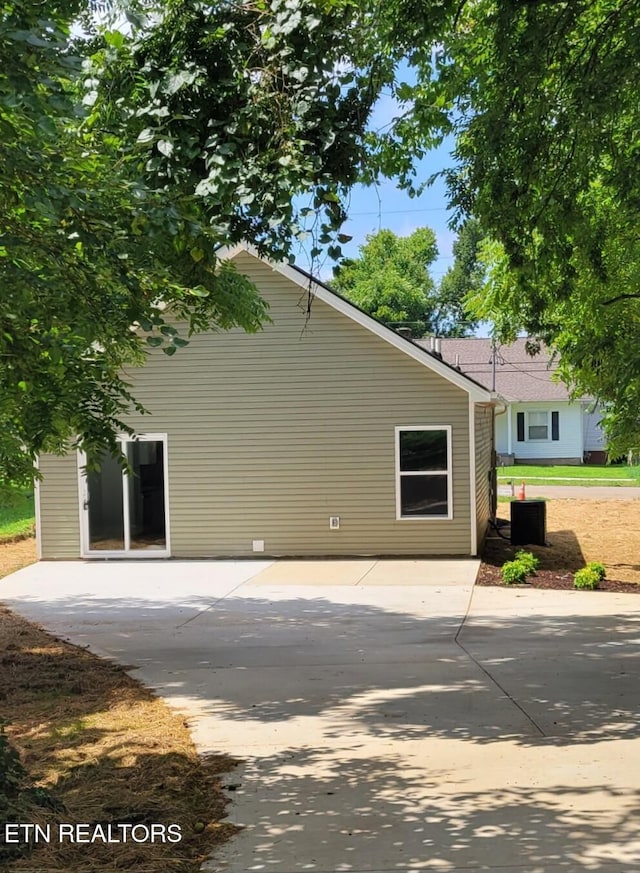 view of side of home with a patio