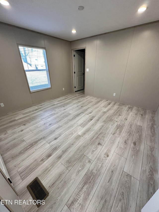 spare room with light hardwood / wood-style flooring