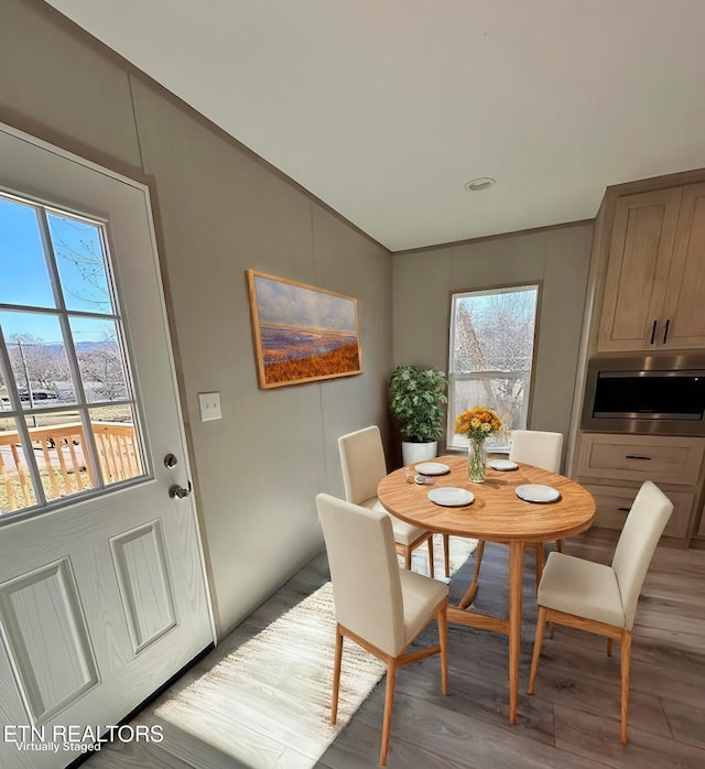 dining space featuring hardwood / wood-style flooring and vaulted ceiling