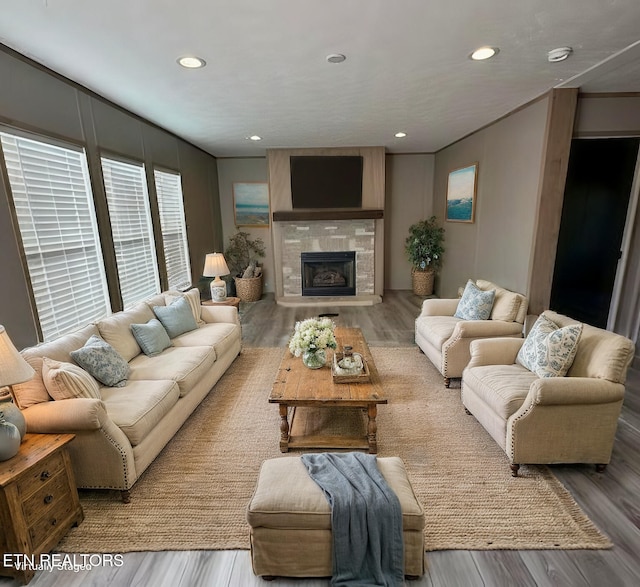 living room featuring hardwood / wood-style floors and a tiled fireplace