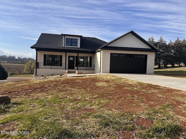 view of front of house with a garage, a porch, and concrete driveway