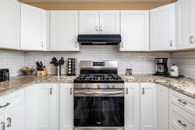 kitchen featuring tasteful backsplash, stainless steel range with gas cooktop, white cabinets, and light stone counters